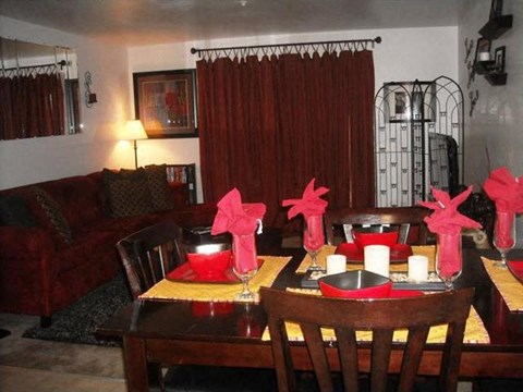 a living room with a table and chairs with decorations on it