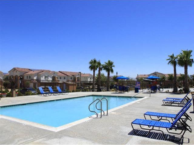 Pool with Lounge Chairs l Casa Bella Apartments in Victorville CA