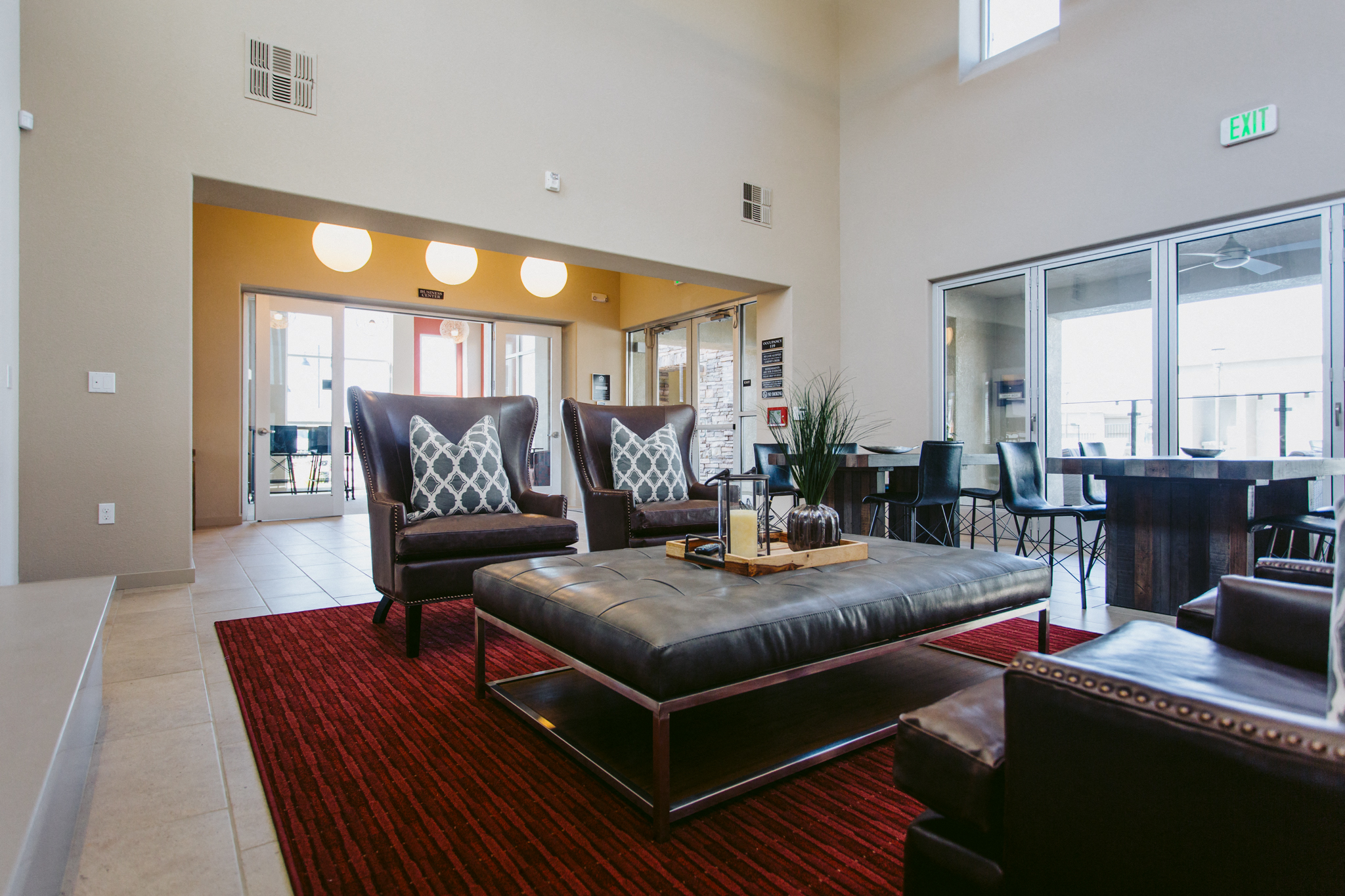A living room with a red carpet and a brown couch.
