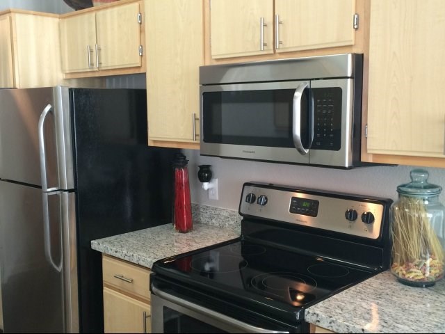 Apartments for Rent in Roseville CA - Pinnacle at Galleria - Modern Kitchen With Stainless Steel Appliance Package, Sleek Granite Countertops, and Abundant Cabinet Space