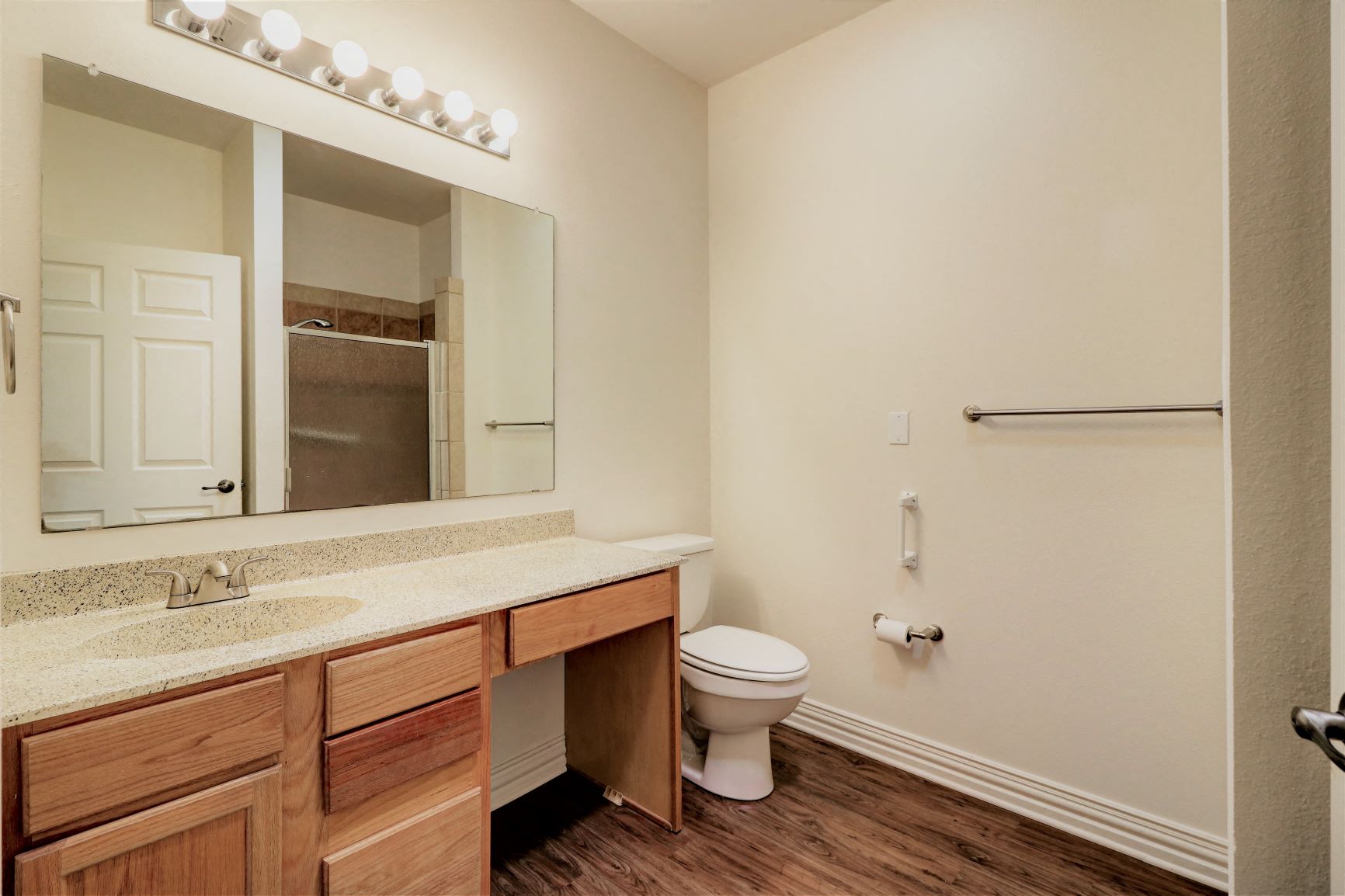 a bathroom with a toilet and a sink and a mirror