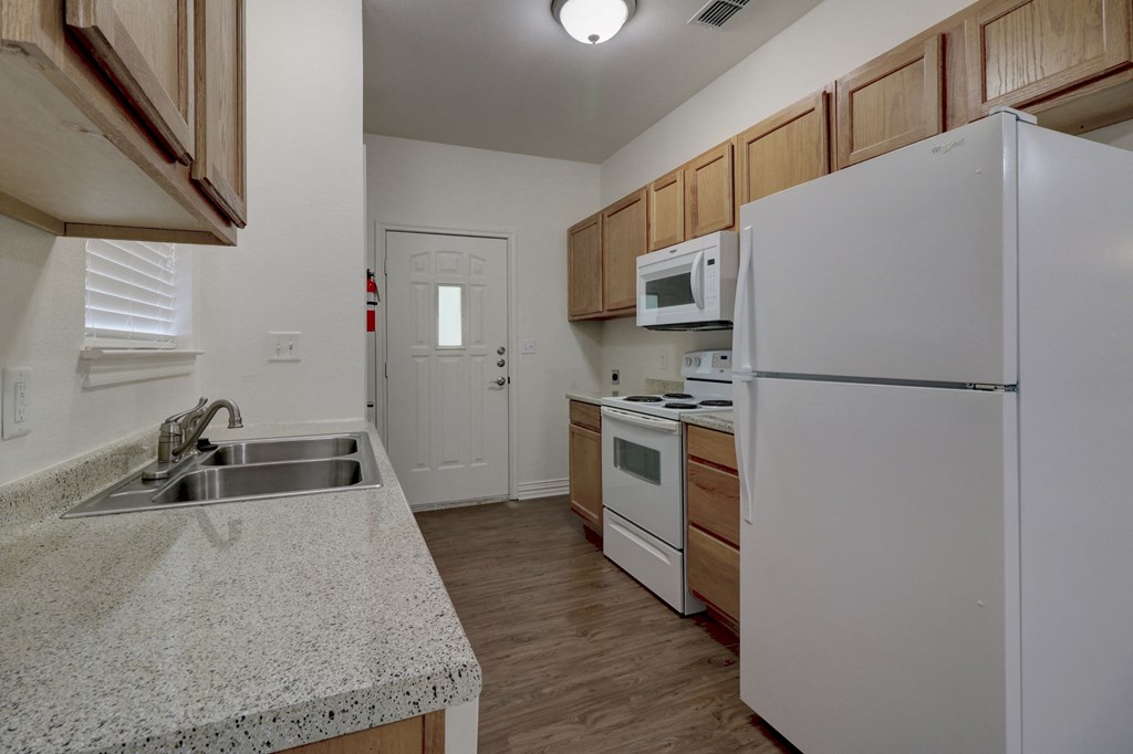 Modern kitchen with sleek appliances in a Legend of Lindale 55+ community apartment