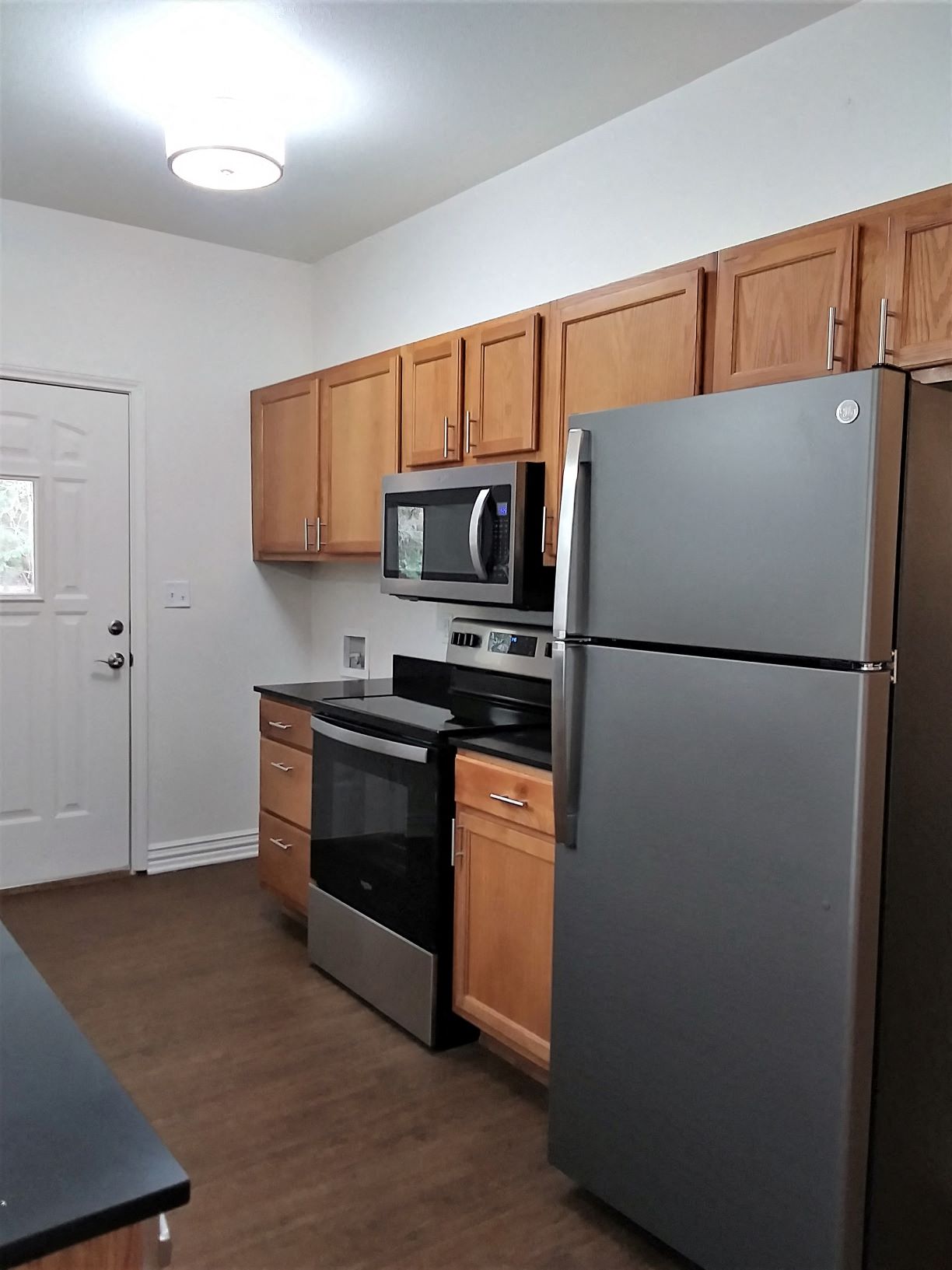 a kitchen with stainless steel appliances and wooden cabinets
