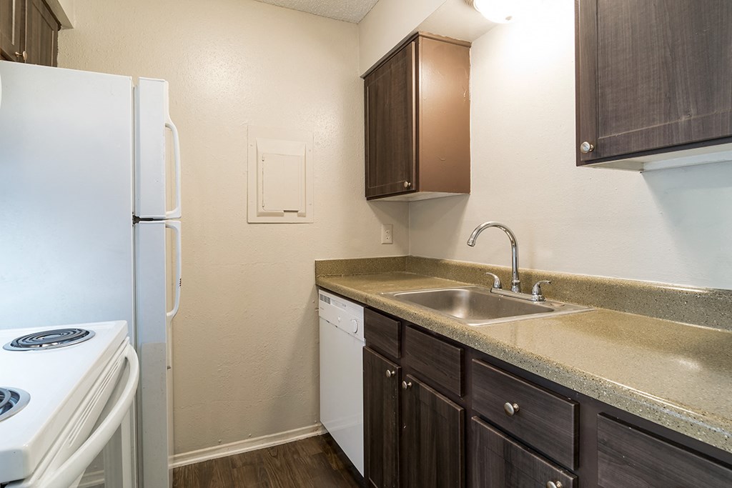 a kitchen with a sink and a refrigerator