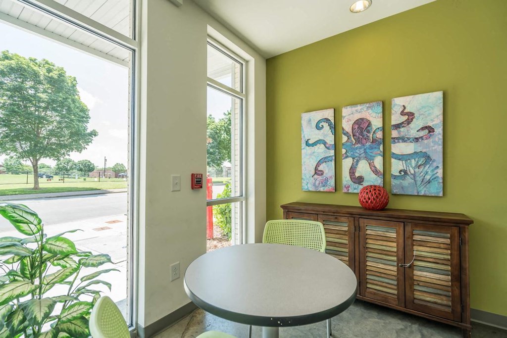 a dining room with a table and chairs and a large window