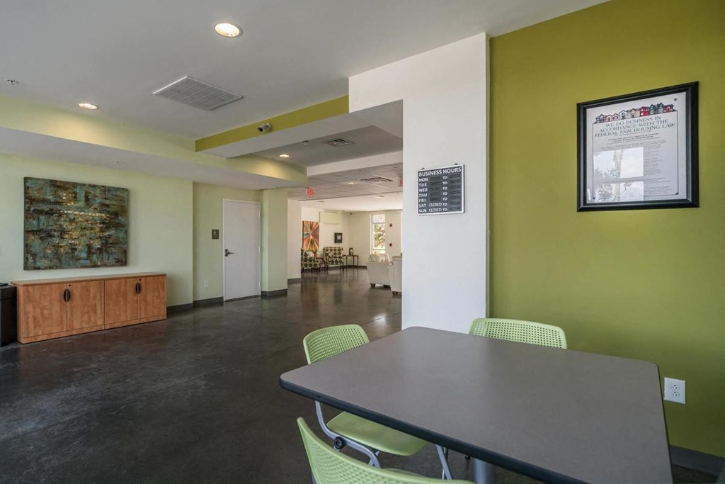 a room with a table and chairs and a bulletin board