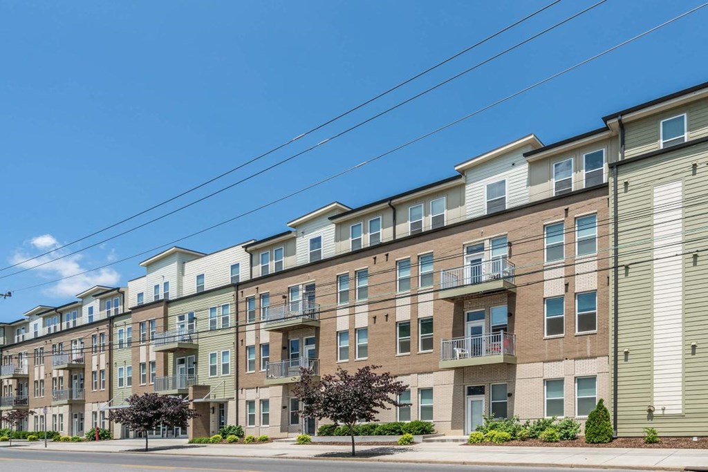 an apartment building on a street with power lines