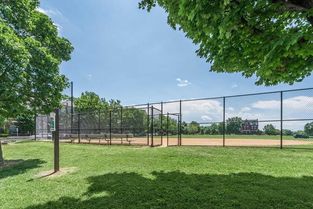 a park with a baseball field and a chain link fence