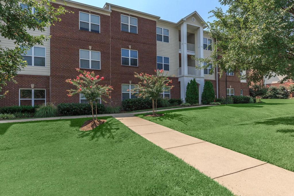 our apartments have a spacious courtyard with green grass and trees
