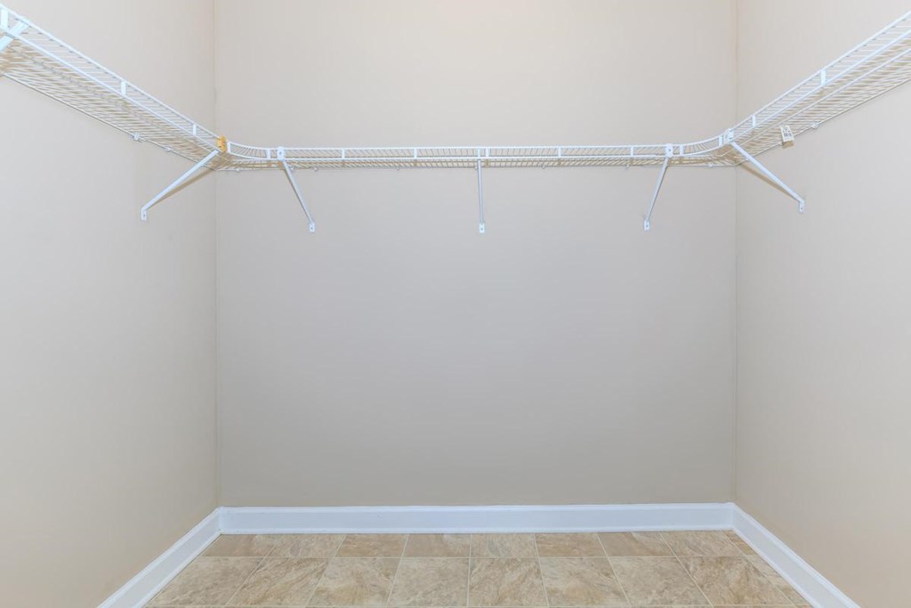 a empty closet with a wire rack on the wall
