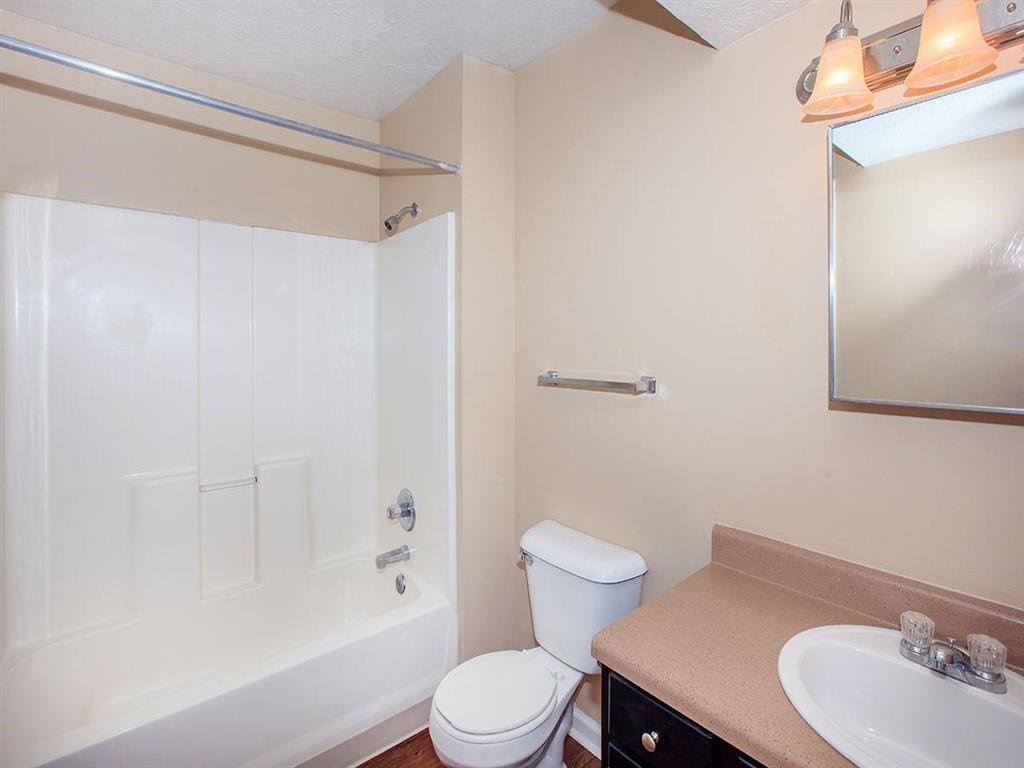 a bathroom with a shower toilet and sink