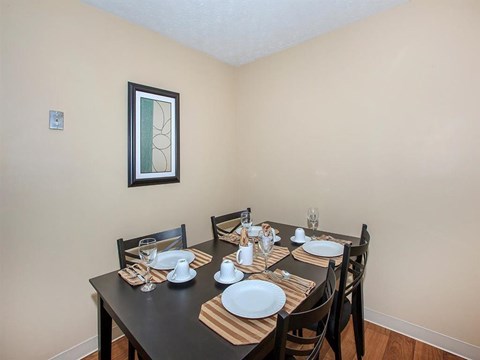 a dining room with a table and chairs