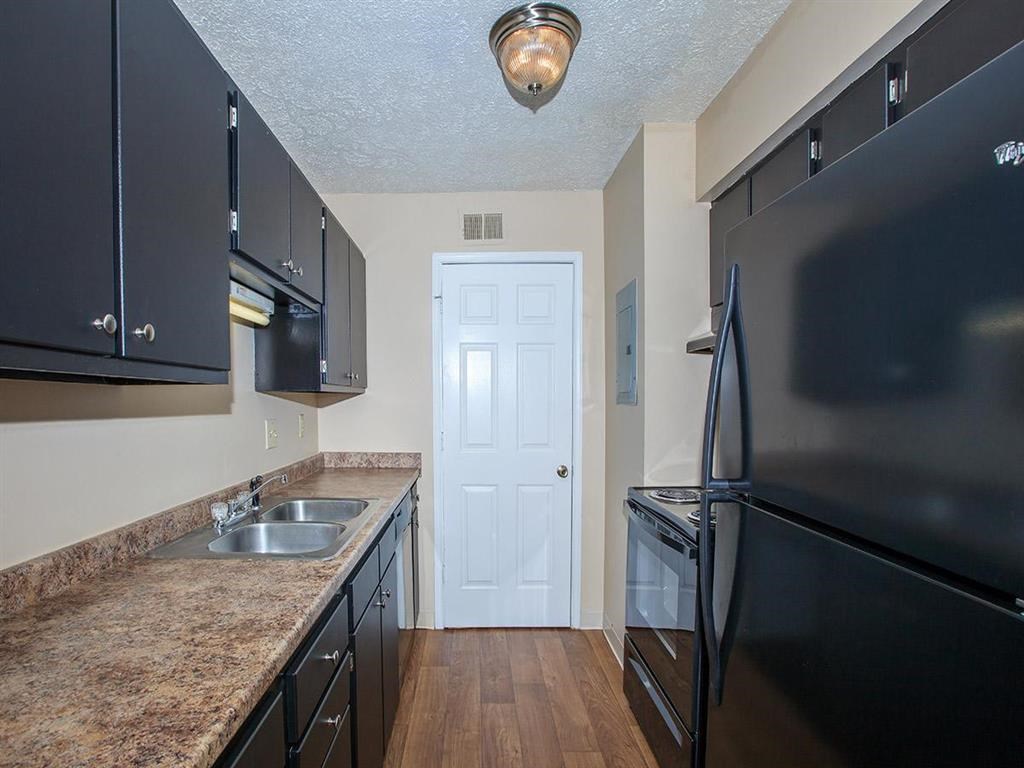 a kitchen with black appliances and granite counter tops