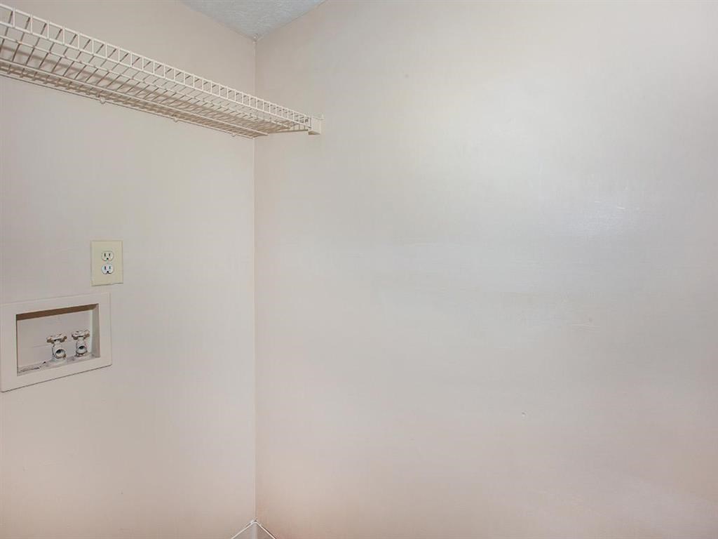 an empty room with a white wall and a light