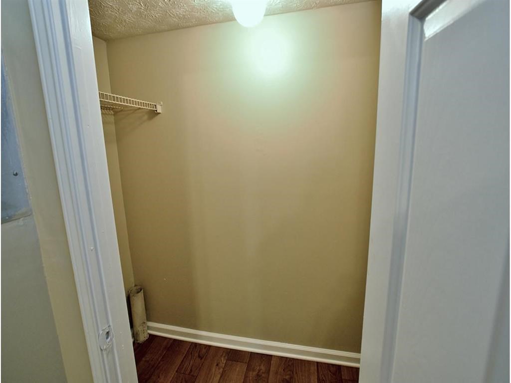 an empty room with a closet and a white door