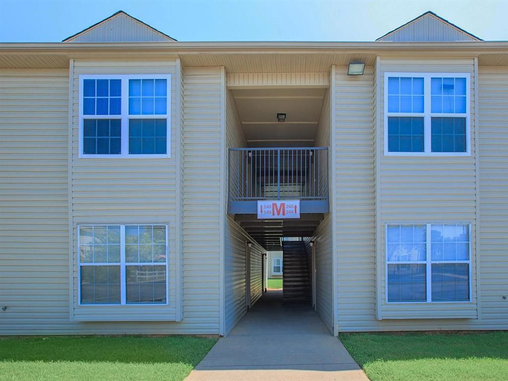 the front of an apartment building with a sidewalk