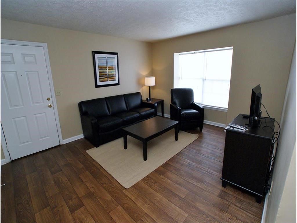 a living room with leather furniture and a tv