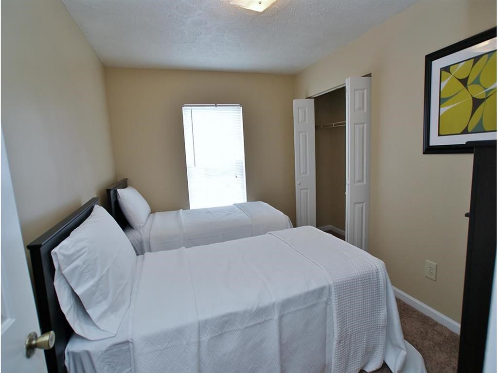 a bedroom with a bed and a closet