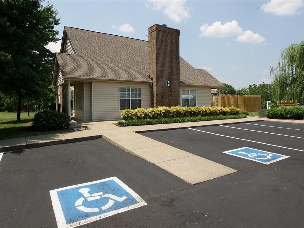 a handicapped parking lot in front of a house