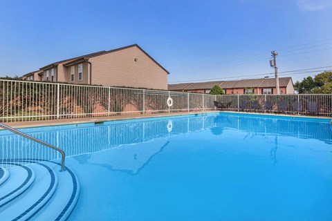 a large swimming pool with a fence around it