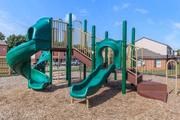 a playground with a slide and other playground equipment