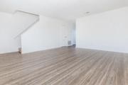 an empty room with white walls and a wooden floor