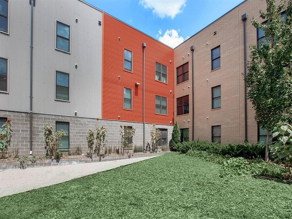 modern apartment buildings with a yard and grass