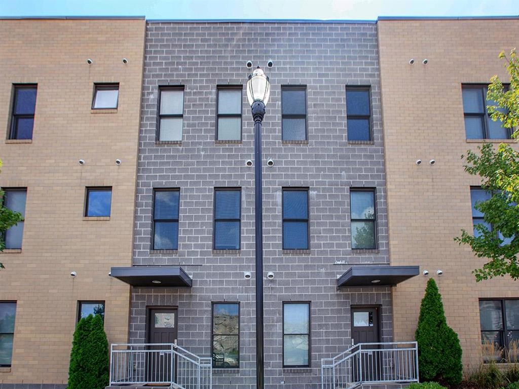 a brick building with a street light in front of it