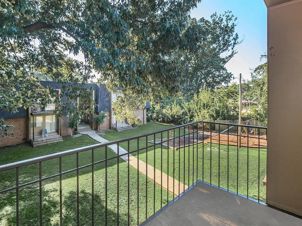 the backyard of a house with a yard and a fence