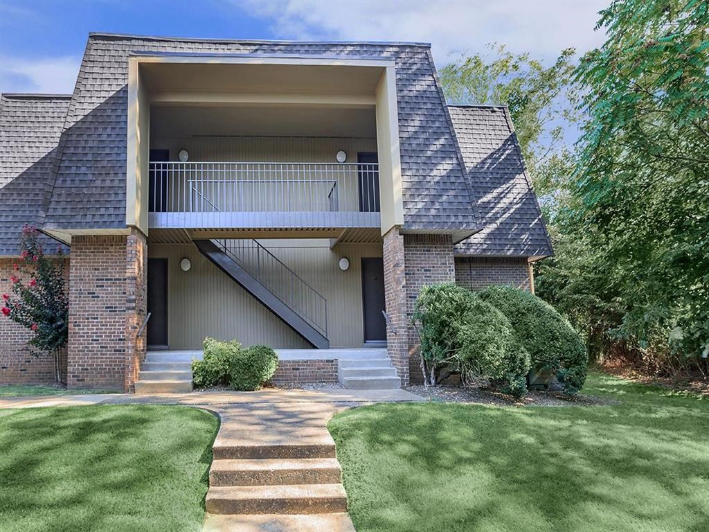 a house with a balcony and a lawn