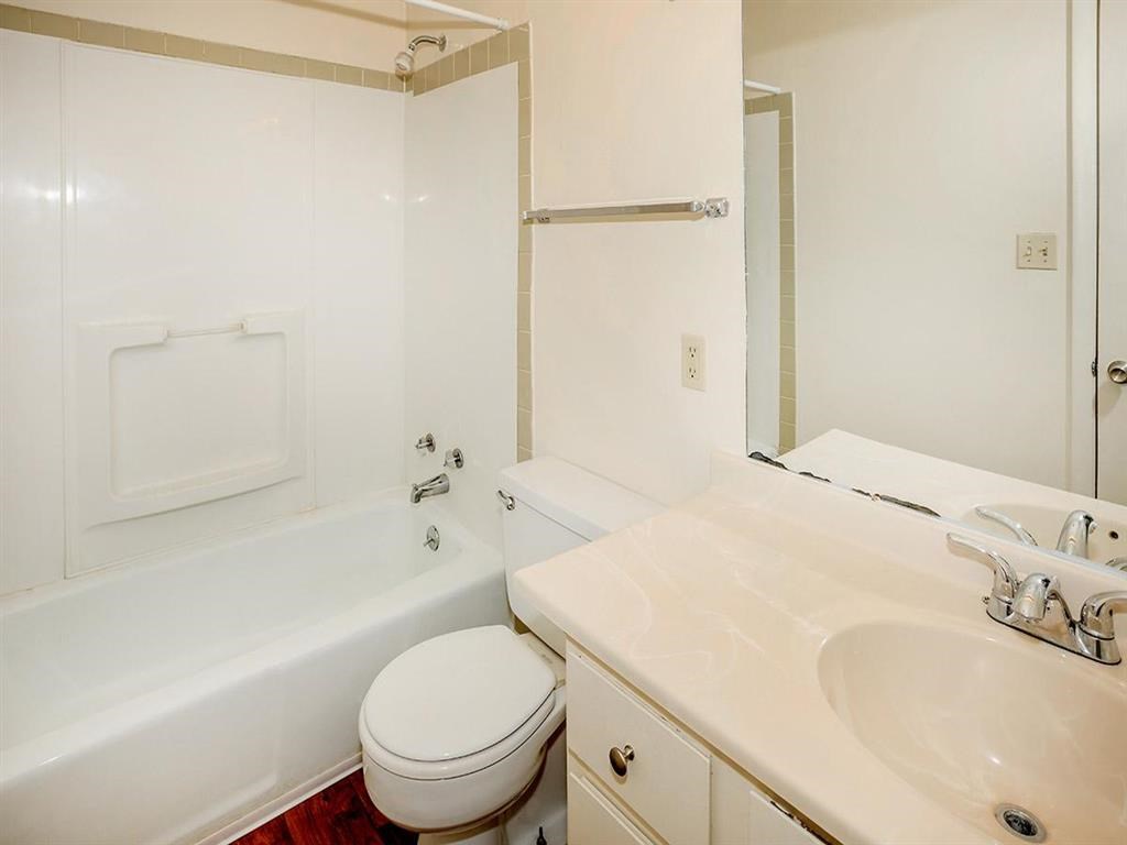 a bathroom with a sink toilet and a bath tub