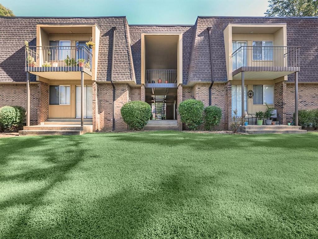 a yard in front of a house with green grass
