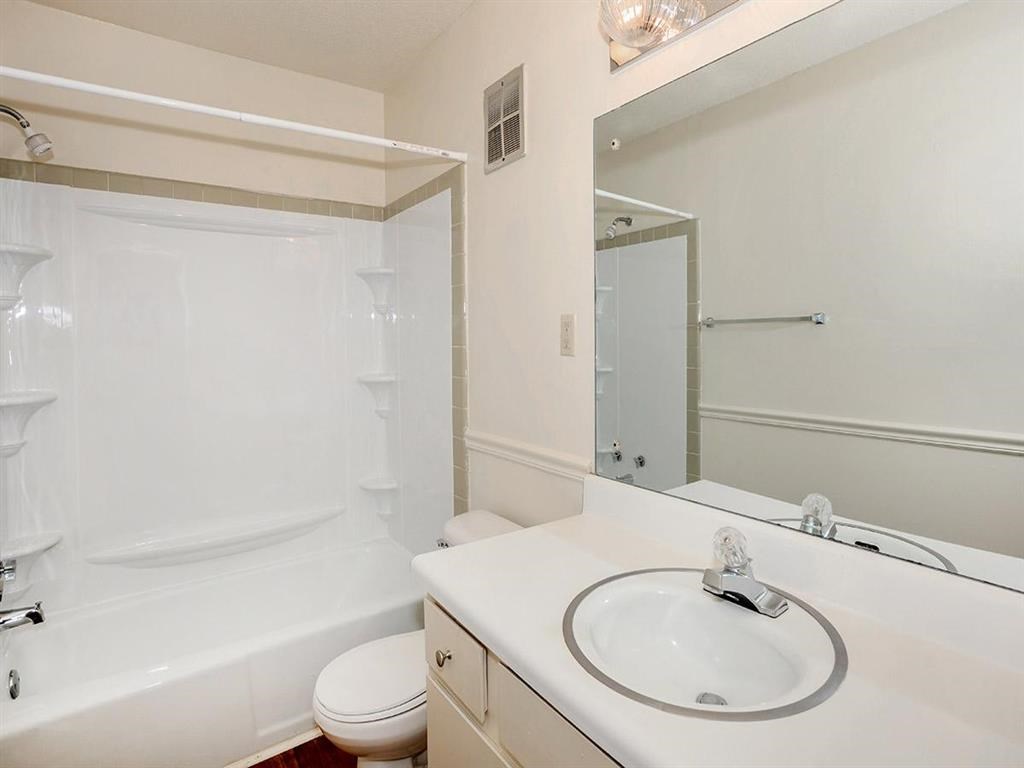 a white bathroom with a sink and a mirror