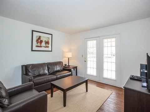 a living room with leather couches and a coffee table