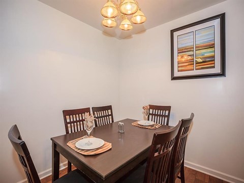a dining room with a table and chairs