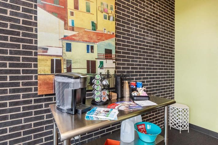 a small kitchen with a coffee maker on a table