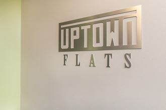a sign for uptown fats on a wall