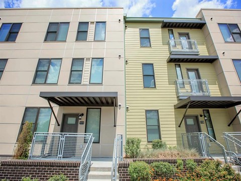 two story apartment buildings with balconies and a staircase