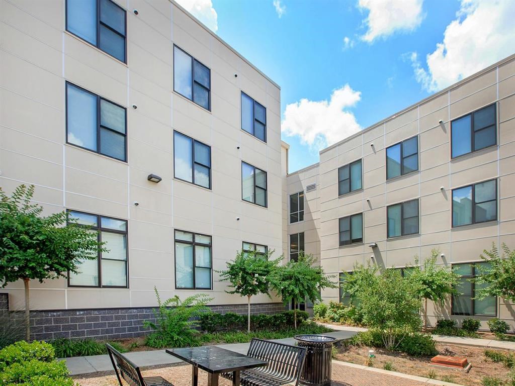 our apartments have an outdoor courtyard with tables and chairs