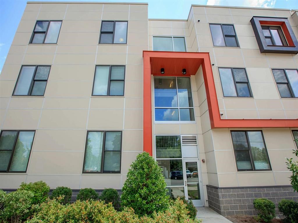 the front of a building with windows and a door