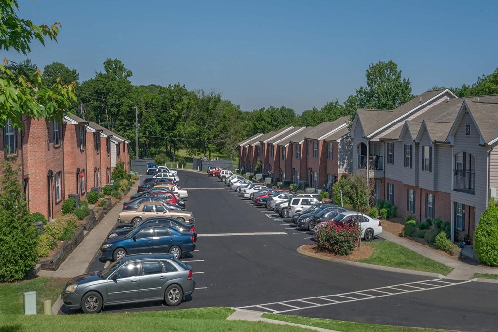 a street filled with cars parked in front of houses