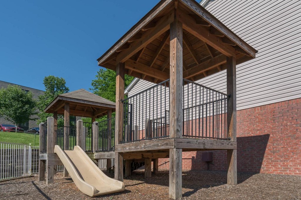 a playground with a slide and a pavilion