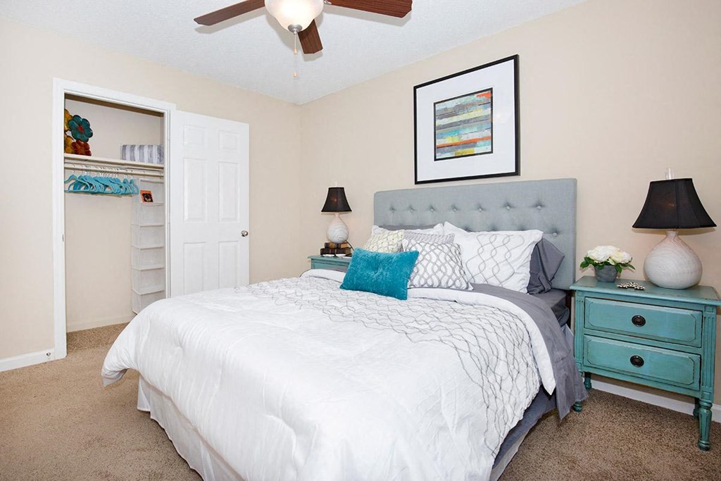 a bedroom with a bed and a ceiling fan