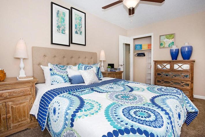 a bedroom with a blue and white bed