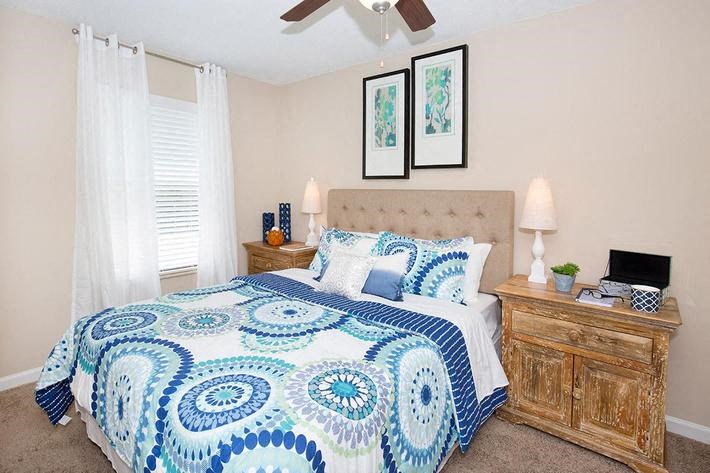 a bedroom with a blue and white bed