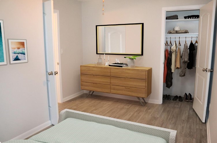 A room with a dresser and a mirror.