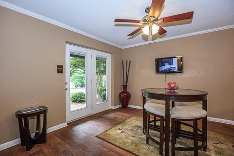 a living room with a round table and a tv