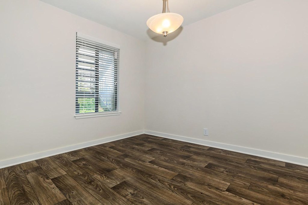 a living room with wood flooring and a window