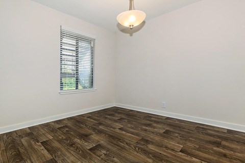 a living room with wood flooring and a window
