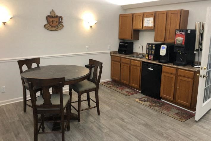 a kitchen with a dining table and a refrigerator